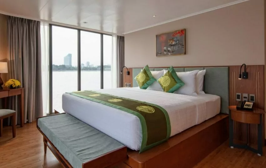 Deluxe cabin with double bed and floor-to-ceiling river-view windows on the Victoria Mekong