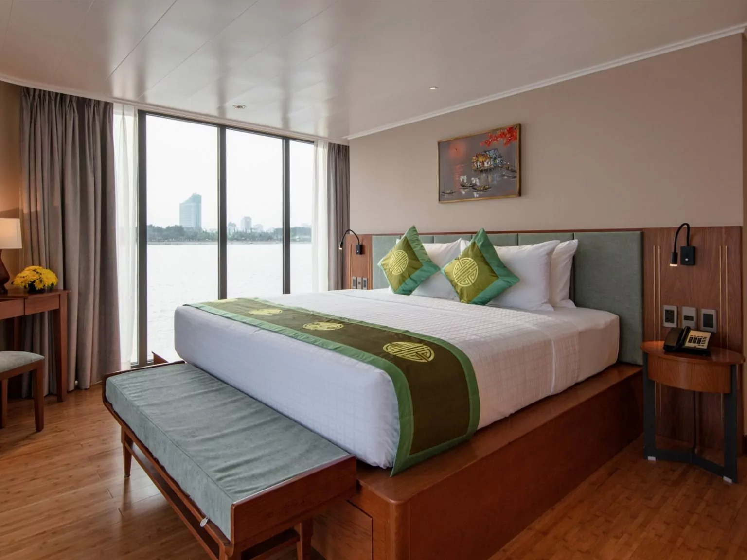 Deluxe cabin with double bed and floor-to-ceiling river-view windows