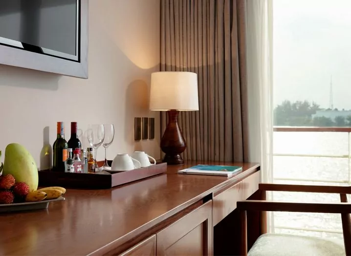 Minibar, welcome fruit and tea station in a Victoria Mekong Deluxe cabin