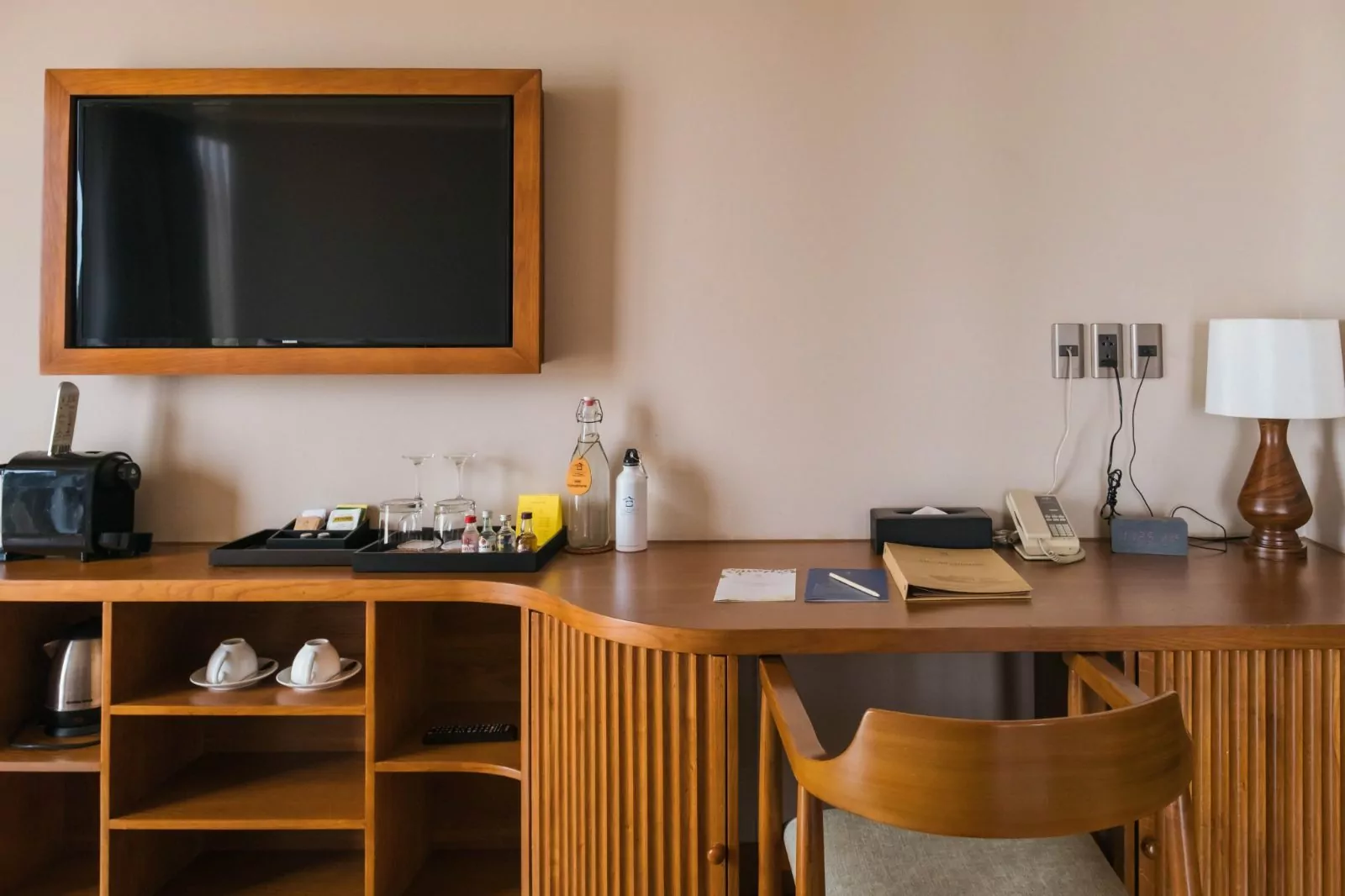 Deluxe stateroom interior with desk, television and minibar