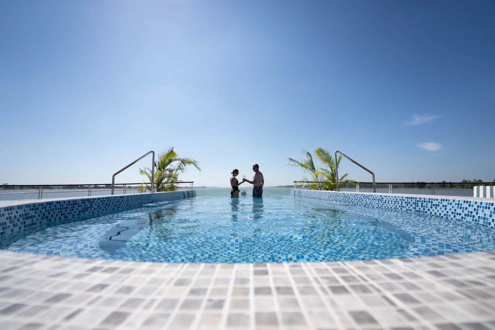 Guests in the infinity pool on the sun deck of the Victoria Mekong cruise