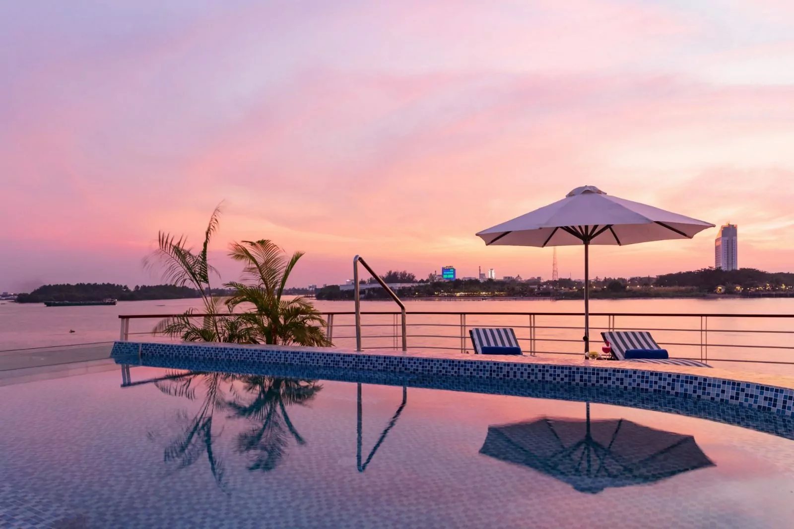 Infinity pool at sunset overlooking the Mekong River