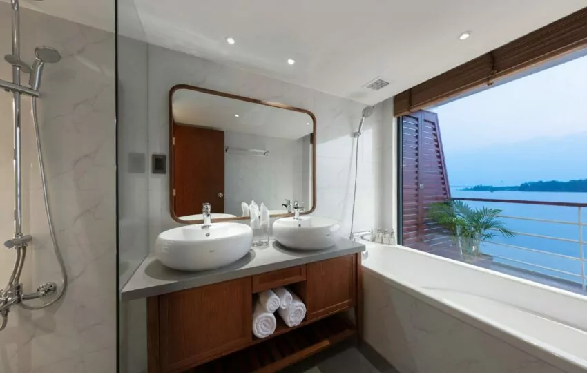 Suite bathroom with double basins and river view on the Victoria Mekong cruise