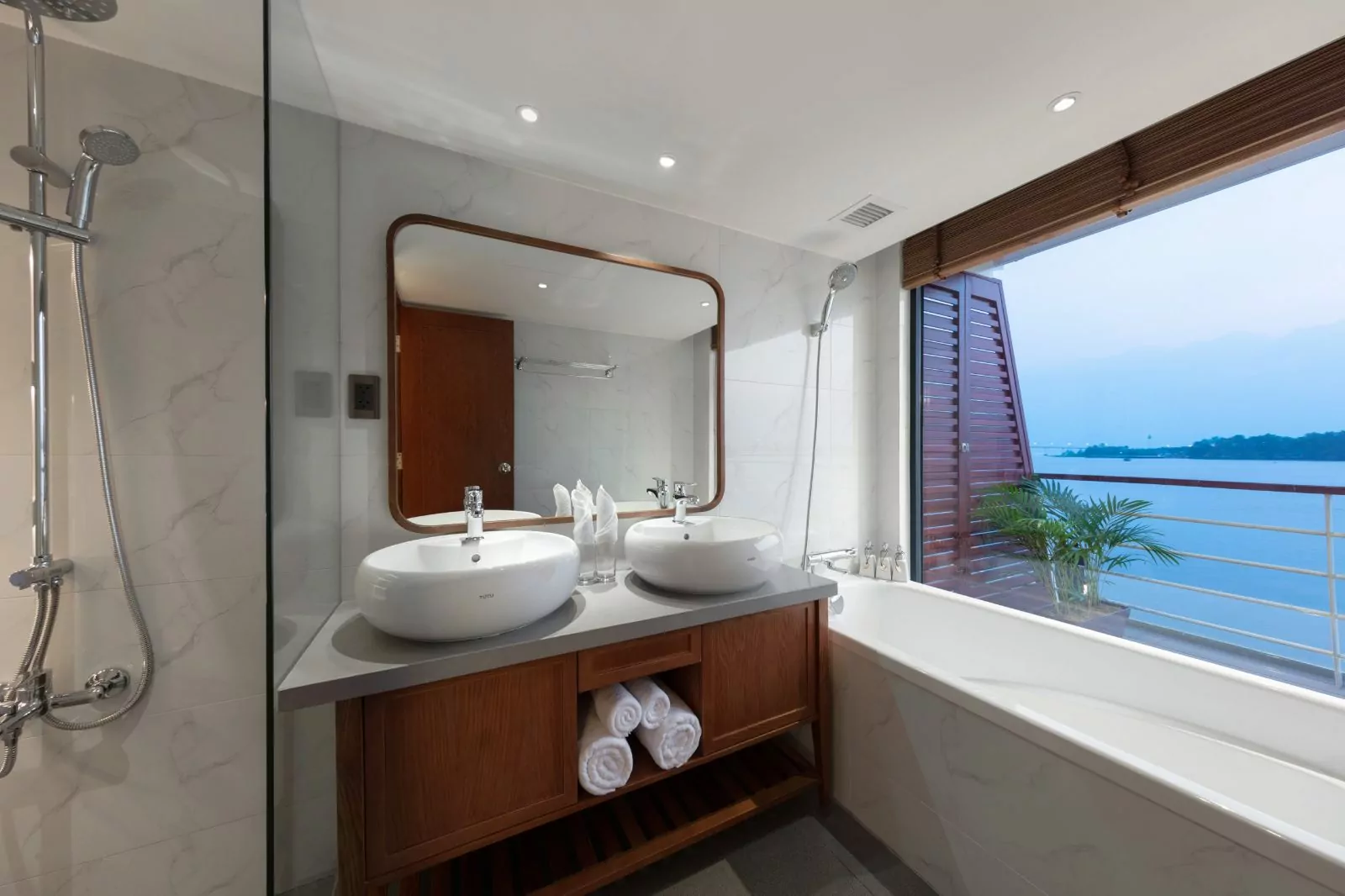 Suite bathroom with double basins and river view