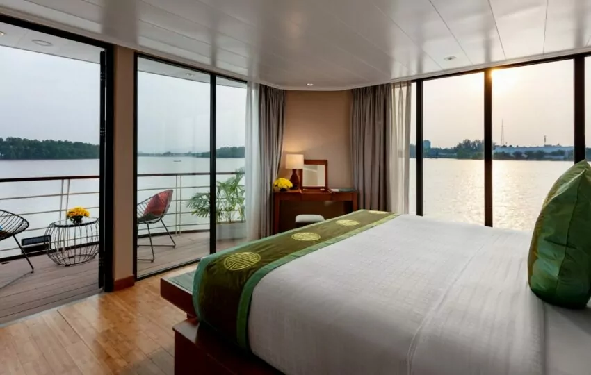 Suite bedroom opening onto the private aft balcony on the Victoria Mekong cruise