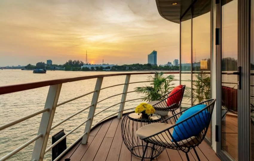 Private aft-facing suite balcony with chairs at sunset on the Victoria Mekong cruise