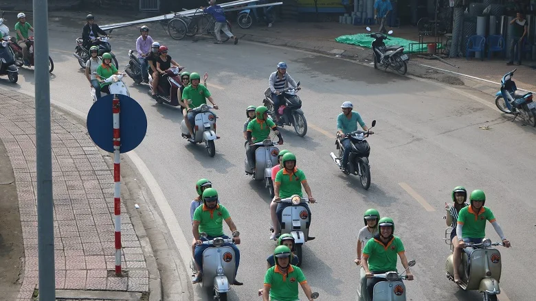 Vespa group riding in Hanoi traffic