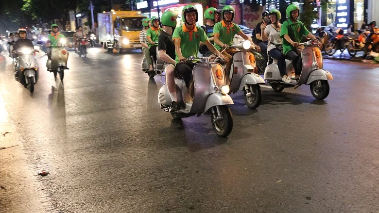 Riding vintage Vespas through Hanoi at night